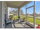 Cozy screened patio with comfortable seating overlooking a serene lake at 24528 Sunrise Dr, Punta Gorda, FL 33980