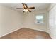 This bedroom has wood floors, a ceiling fan, a window, and a closet at 3233 Wood Thrush Dr # 23C, Punta Gorda, FL 33950