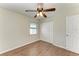 This bedroom has wood floors, a ceiling fan, a window, and a closet at 3233 Wood Thrush Dr # 23C, Punta Gorda, FL 33950