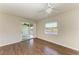 Comfortable bedroom featuring wood-look floors, ceiling fan, and water views at 3233 Wood Thrush Dr # 23C, Punta Gorda, FL 33950