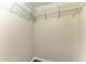 This closet has wood floor and a shelf with bars for hanging items at 3233 Wood Thrush Dr # 23C, Punta Gorda, FL 33950