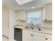 Charming kitchen with stainless steel sink and appliances under a sunny skylight at 3233 Wood Thrush Dr # 23C, Punta Gorda, FL 33950