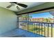 Screened lanai featuring tile flooring, ceiling fan, and a view of the water at 3233 Wood Thrush Dr # 23C, Punta Gorda, FL 33950
