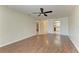 Spacious living room featuring wood-look floors, a ceiling fan, and lots of natural light at 3233 Wood Thrush Dr # 23C, Punta Gorda, FL 33950