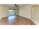 Living room with wood floors and sliding glass doors to a screened lanai at 3233 Wood Thrush Dr # 23C, Punta Gorda, FL 33950
