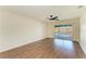 Bedroom with wood floors, a ceiling fan, and sliding glass door to a balcony at 3233 Wood Thrush Dr # 23C, Punta Gorda, FL 33950