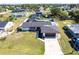 Aerial view of the home featuring a long driveway, mature trees, and fenced-in yard at 3348 Pinetree St, Port Charlotte, FL 33952