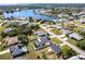 Aerial view of the home with screened-in pool near a scenic lake at 3348 Pinetree St, Port Charlotte, FL 33952
