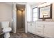 Modern bathroom with a walk-in shower, stylish vanity, and wood-look flooring at 3348 Pinetree St, Port Charlotte, FL 33952