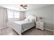 Bright bedroom with a white bed, ceiling fan, and natural light from the window at 3348 Pinetree St, Port Charlotte, FL 33952