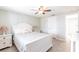 Cozy bedroom featuring a white bed, ceiling fan, and two bedside tables with lamps at 3348 Pinetree St, Port Charlotte, FL 33952