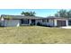 Charming one-story home with well-manicured lawn and freshly mulched flower beds in front of the house at 3348 Pinetree St, Port Charlotte, FL 33952