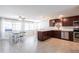 Bright kitchen with stainless steel appliances, granite counters, and wine rack with access to dinning area at 3348 Pinetree St, Port Charlotte, FL 33952