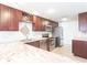 Well-appointed kitchen with stainless steel appliances, granite counters, dark wood cabinets, and a tiled backsplash at 3348 Pinetree St, Port Charlotte, FL 33952