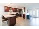 Modern kitchen featuring stainless steel appliances, granite countertops, dark wood cabinetry, and tiled backsplash at 3348 Pinetree St, Port Charlotte, FL 33952