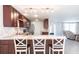 Open kitchen featuring stainless appliances, granite countertops, dark wood cabinetry, with bar stool seating at 3348 Pinetree St, Port Charlotte, FL 33952