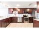 Updated kitchen with stainless steel appliances, granite countertops, and wood cabinetry at 3348 Pinetree St, Port Charlotte, FL 33952