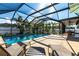 Relaxing pool with lounge chairs and lush landscaping at 3348 Pinetree St, Port Charlotte, FL 33952