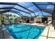 Relaxing screened-in pool area with outdoor seating, perfect for enjoying sunny days and entertaining guests at 3348 Pinetree St, Port Charlotte, FL 33952