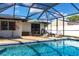 Relaxing screened-in pool area features outdoor seating and crystal-clear water at 3348 Pinetree St, Port Charlotte, FL 33952