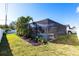 The fenced-in backyard features a screened-in pool and tropical landscaping at 3348 Pinetree St, Port Charlotte, FL 33952
