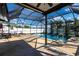 Enclosed pool area with plenty of seating and tropical landscaping at 3348 Pinetree St, Port Charlotte, FL 33952