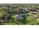 An aerial view of a single story home surrounded by trees and other homes in the distance at 3946 Cinderella Rd, North Port, FL 34286