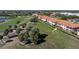 Scenic aerial view of condo community on a golf course with palm trees and lush green landscaping at 3959 San Rocco Dr # 612, Punta Gorda, FL 33950