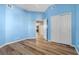 Bright blue bedroom featuring wood-look floors, and a closet, enhancing the inviting atmosphere at 3959 San Rocco Dr # 612, Punta Gorda, FL 33950