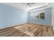 This spacious bedroom boasts wood flooring, a ceiling fan, and a large window with shutters at 3959 San Rocco Dr # 612, Punta Gorda, FL 33950