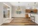 Dining area with wood laminate flooring, modern lighting, and sliding glass door to patio at 3959 San Rocco Dr # 612, Punta Gorda, FL 33950