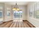 Light dining area with laminate floors, shutters, modern light fixture and access to screened patio at 3959 San Rocco Dr # 612, Punta Gorda, FL 33950