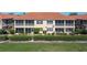 Rear exterior view of home with large, screened lanai and well-maintained landscaping at 3959 San Rocco Dr # 612, Punta Gorda, FL 33950