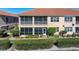 Exterior view of the home featuring a screened lanai and neatly landscaped backyard at 3959 San Rocco Dr # 612, Punta Gorda, FL 33950