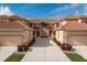 Mediterranean-style condo boasts a symmetrical facade, terracotta roof, manicured landscaping, and inviting driveway at 3959 San Rocco Dr # 612, Punta Gorda, FL 33950