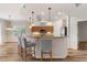 Kitchen with breakfast bar with granite countertops, three stools, and modern lighting at 3959 San Rocco Dr # 612, Punta Gorda, FL 33950