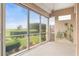 Screened-in lanai with a ceiling fan overlooking a beautiful green landscape and natural light at 3959 San Rocco Dr # 612, Punta Gorda, FL 33950