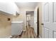 Bright laundry area with stylish wood-look floors, storage cabinets, and a glimpse into the home's interior at 3959 San Rocco Dr # 612, Punta Gorda, FL 33950