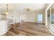 Open-concept living area with breakfast bar, light walls, and laminate floors at 3959 San Rocco Dr # 612, Punta Gorda, FL 33950