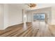 Bright living room with light walls, wood floors, decorative molding, and sliding door to screened patio at 3959 San Rocco Dr # 612, Punta Gorda, FL 33950