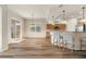 Open floor plan with hardwood floors, a breakfast bar and access to an outdoor patio through sliding glass doors at 3959 San Rocco Dr # 612, Punta Gorda, FL 33950