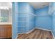 Spacious, light blue walk-in closet with wood-look floors and ample shelving for optimal storage in this lovely home at 3959 San Rocco Dr # 612, Punta Gorda, FL 33950