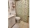 A well-kept bathroom with a green leaf curtain and a sink at 4000 Oakview Dr # L2, Punta Gorda, FL 33980