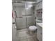 Bathroom with a toilet, shower with glass doors, and a white sink at 4000 Oakview Dr # L2, Punta Gorda, FL 33980