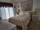 Comfortable bedroom featuring a floral-patterned bedspread, and plenty of natural light at 4000 Oakview Dr # L2, Punta Gorda, FL 33980