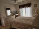 Bright bedroom with a dresser, blinds and a bed with floral patterns at 4000 Oakview Dr # L2, Punta Gorda, FL 33980