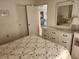 Bedroom with a mirror, dresser, bed with floral pattern, and a ceiling fan at 4000 Oakview Dr # L2, Punta Gorda, FL 33980