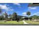 View of the community clubhouse with benches and palm trees at 4000 Oakview Dr # L2, Punta Gorda, FL 33980