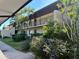 Charming condo building featuring lush landscaping, a balcony, and well-maintained grounds at 4000 Oakview Dr # L2, Punta Gorda, FL 33980