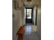 Bright hallway features tile flooring, a bench, a closet, and a dark front door at 4000 Oakview Dr # L2, Punta Gorda, FL 33980